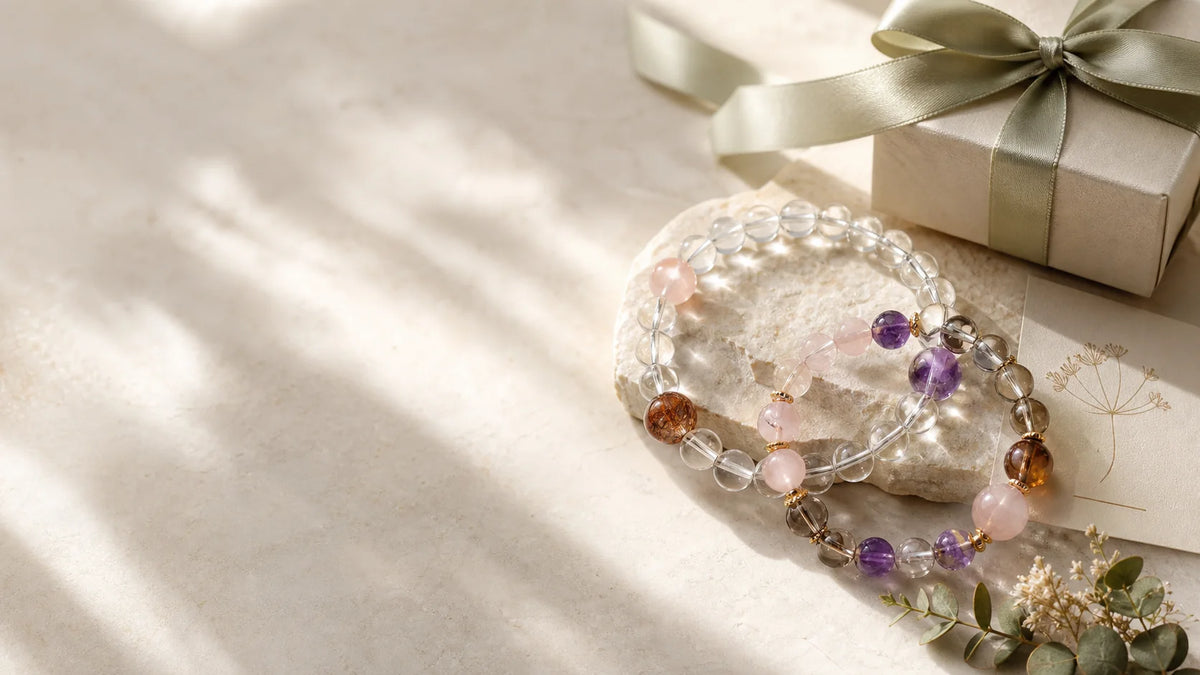 Amethyst and smoky quartz bracelet styled as a premium crystal gift on a soft QZENI surface